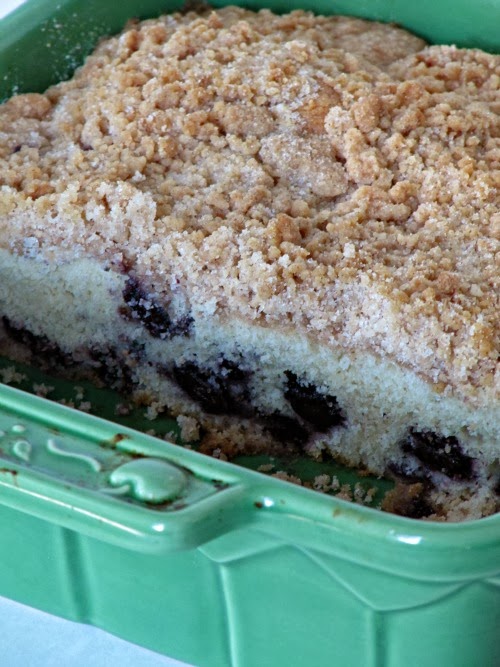 Blueberry Coffee Cake with Crumble Topping in a green baking dish. 
