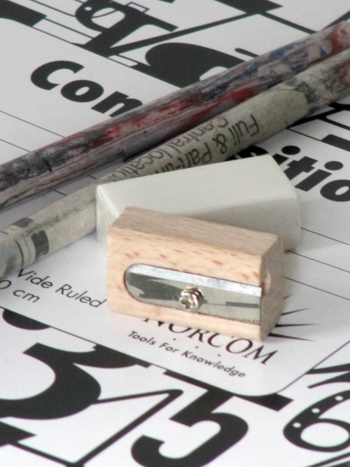 pencils and composition book on a desk'