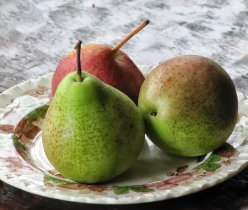 three pears on a plate.