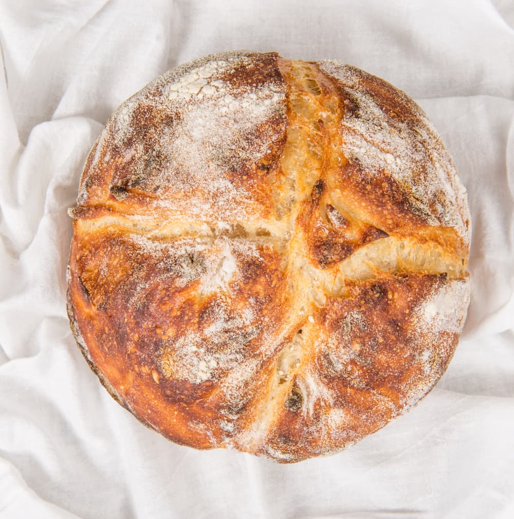 Crusty Sour Dough Bread on a white cloth. 