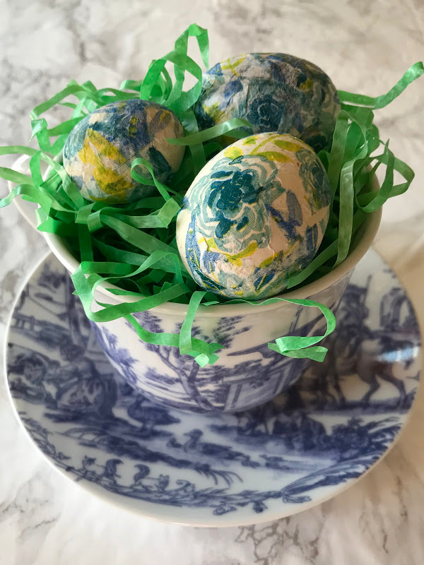 decoupage eggs in a toile cup and saucer