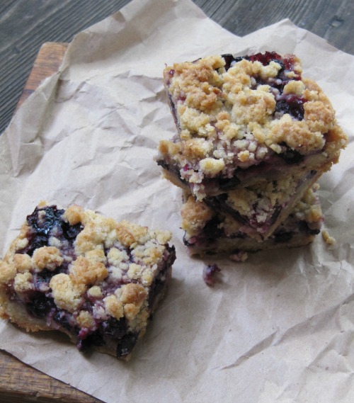 Blueberry crumble bars on brown paper. 