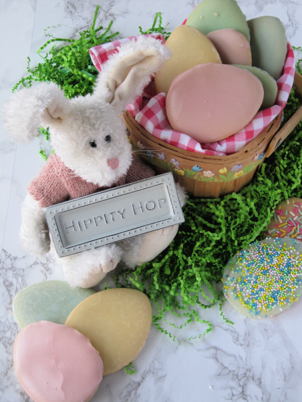 stuffed bunny with a basket of pastel Easter egg cookies