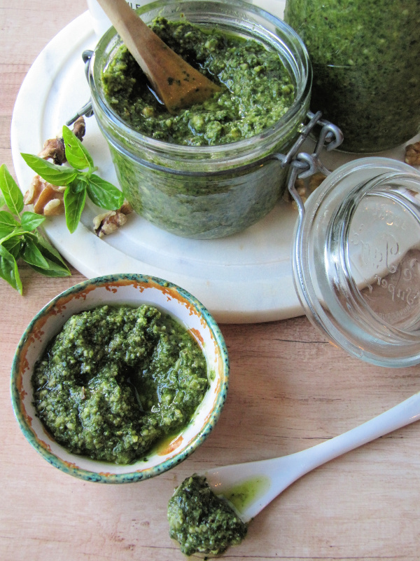 Basil walnut pesto in a jar and a small bowl. 