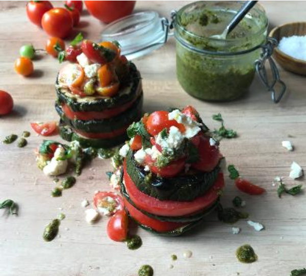 Grilled Zucchini and Tomato Stack Salad  with a jar of pesto. 