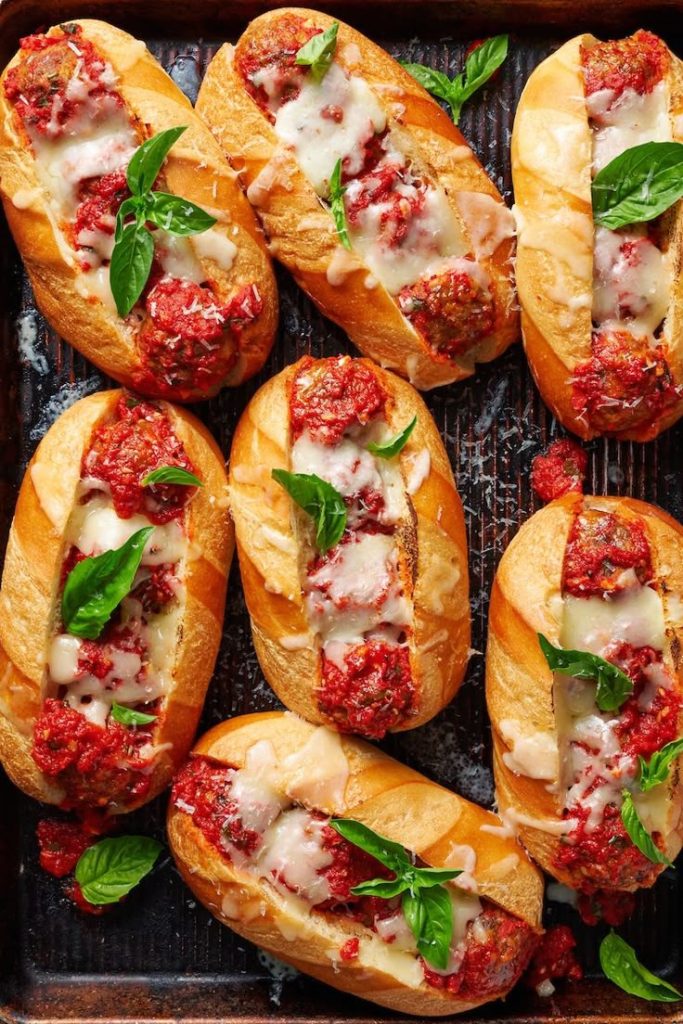 Meatball subs on a baking tray. 