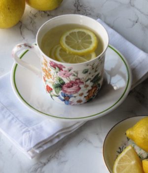 flowered cup with lemons floating in it