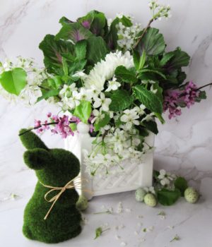 Flower arrangement with cherry blossoms and a moss covered bunny
