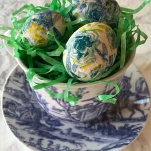 decoupage eggs in a toile cup and saucer