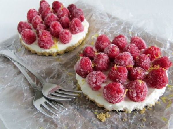 two tarts with raspberries on top