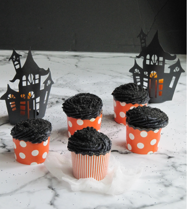 pumpkin carrot cake cupcakes with black buttercream frosting and black sanding sugar pinecones & acorns