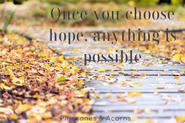 fall leaves along a wood path with the quote once you choose hope anything is possible quote