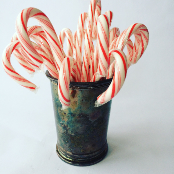 tarnished silver mint julep cup filled with candy canes