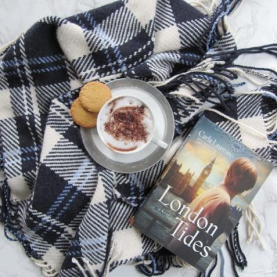 The London Tides Flatlay with a blue plaid scarf hot chocolate in white cup with two cookies