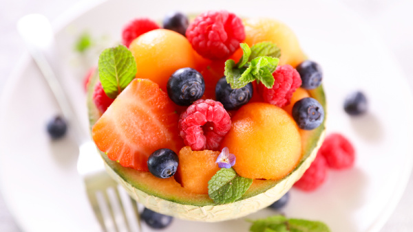 5 Easy Ways to Drink More Water, cantaloupe filled with berries and mint