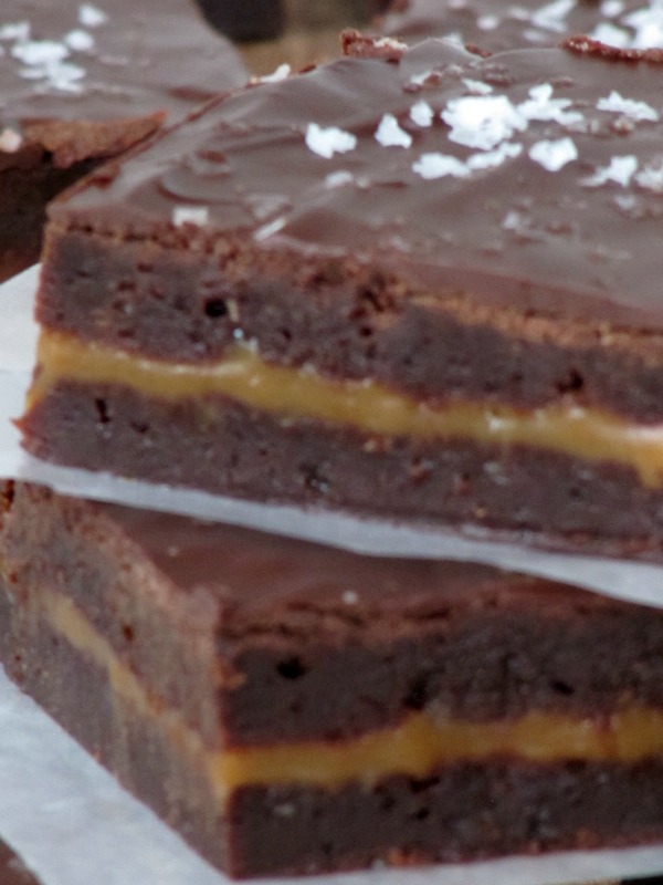 two caramel stuffed brownies layered on top of one another