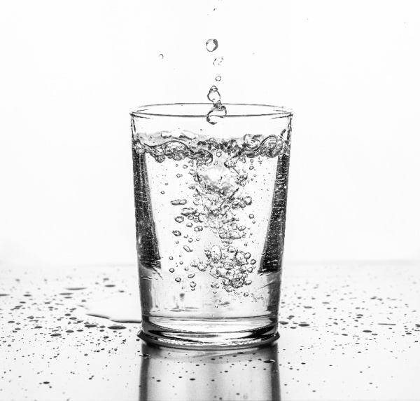 5 Easy Ways to Drink More Water, water poured into a clear glass. 