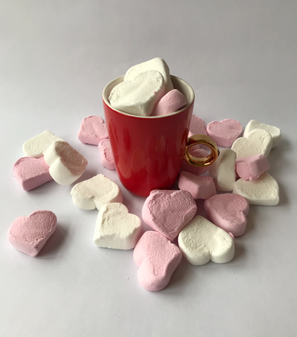 pink and white heart marshmallows in a cup