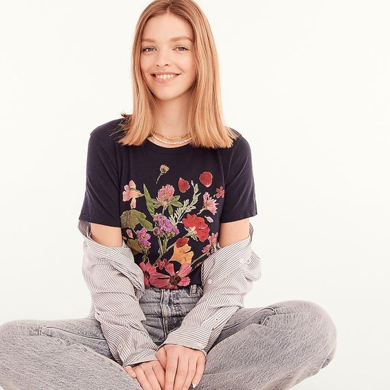 Girl wearing a blu t-shirt with flowers
