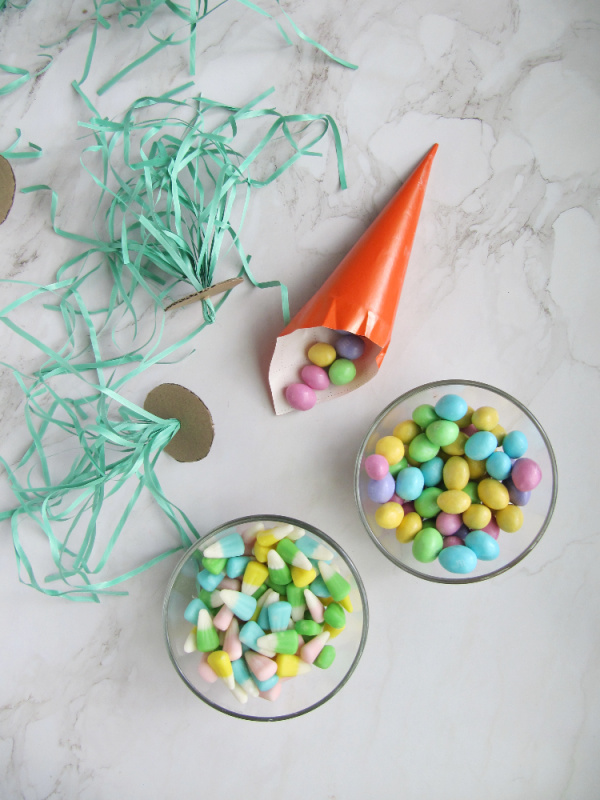 surprise easter carrot with bowls of pastel easter candy