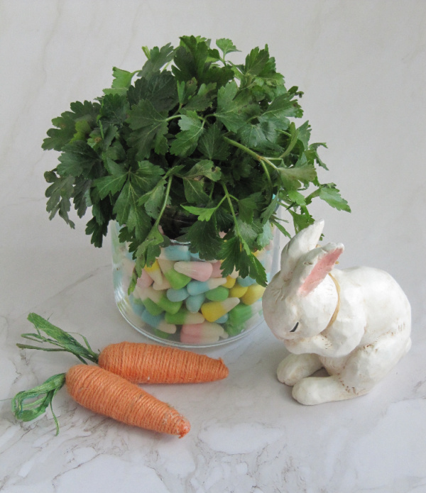 weekend meanderings Easter decorations small rabbit with two straw carrots and a vase filled with greens