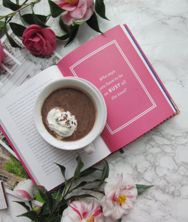 flatly who says you have to be busy all the time with flowers hot chocolate and a book
