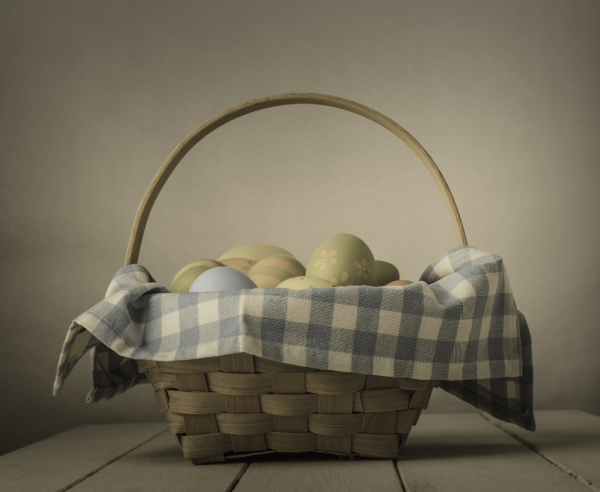 Monday Musings wicker basket with a gingham napkins filled with easter eggs