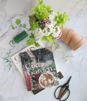 Friday Favorites flatlay with terracotta pots garden books sizzors and twine
