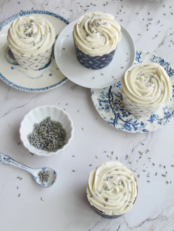 lavender cupcakes with marshmallow buttercream frosting on blue and white vintage plates