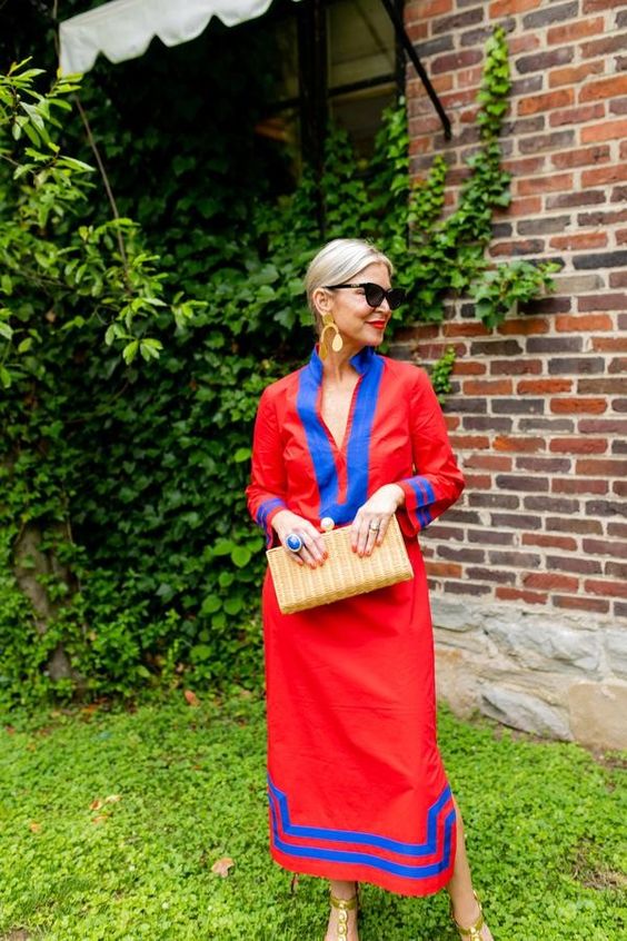 Weekend Meanderings Blond woman with hair in a bun wearing a red caftan with blue piping