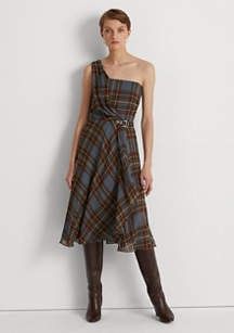 woman wearing a brown and green plaid one shoulder dress with boots