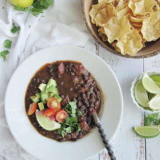easy black bean soup one white bowl and wood bowl of scoops chips