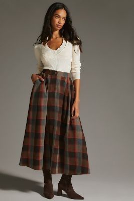 Friday Favorites woman in a pair of black boots plaid skirt and white shirt