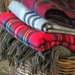 vintage plait throw blankets in a wicker basket