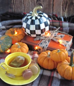 weekend meanderings orange pumpkins black and white pumpkin and a cup of tea in a yellow cut and saucer