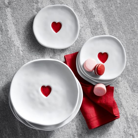 Friday Favorites finds, 3 stacks of white plates with one red heart in the center on a red napkin. 