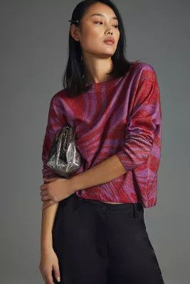 Friday Finds Woman wearing black pants and a red and fuchsia sweater. 