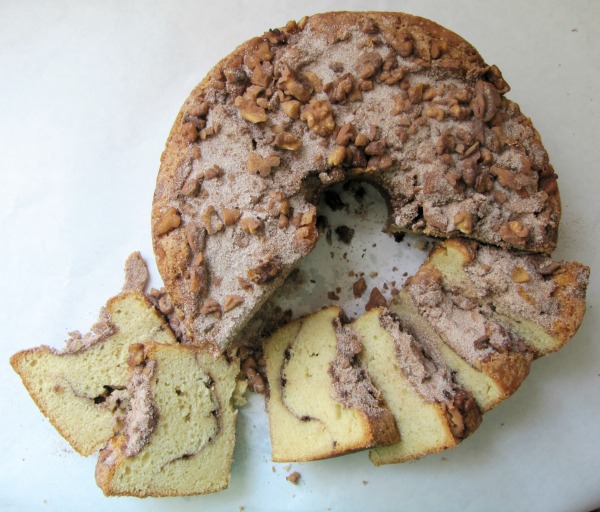 A cinnamon walnut coffeecake cut with six slices on the side. 