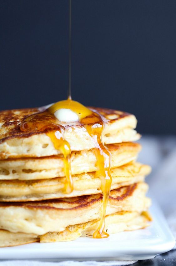 Brown sugar pancakes on a stack with butter and syrup. 
