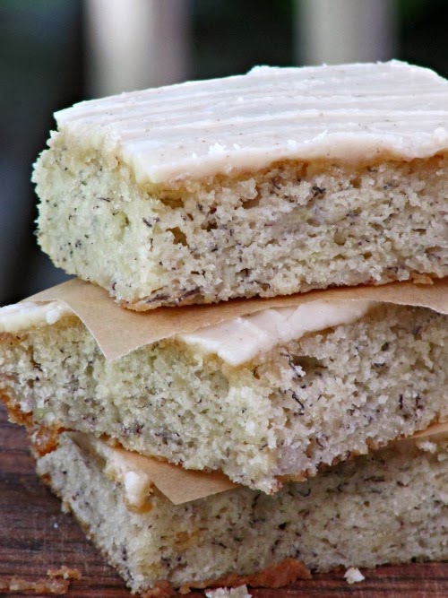 Banana bars with browned butter glaze stacked in a pile. 