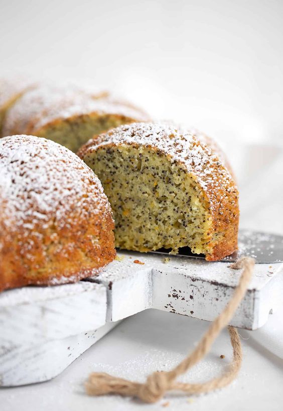 Orange Poppy Seed Cake on a white cutting board. 