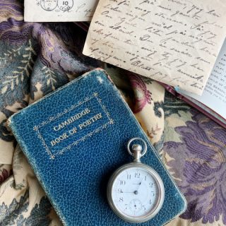 flatlay with book of poetry and vintage letters