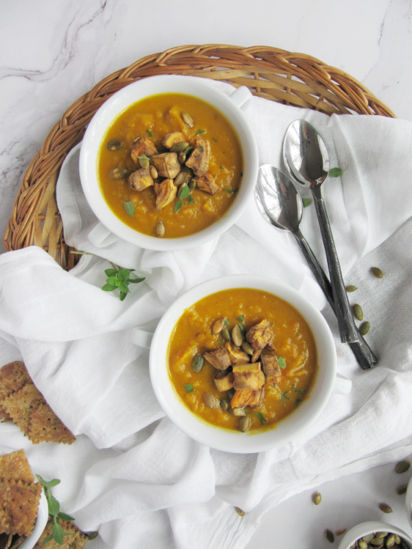 turmeric sweet potato and pumpkin soup in white bowls