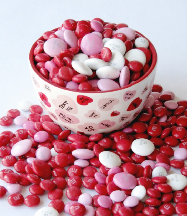 white bowl with red, pink and white M & M candy for Valentines day.