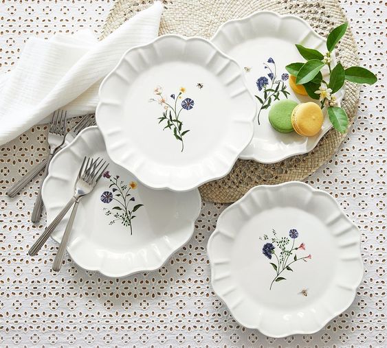 White scolloped salad plates with flowers. 