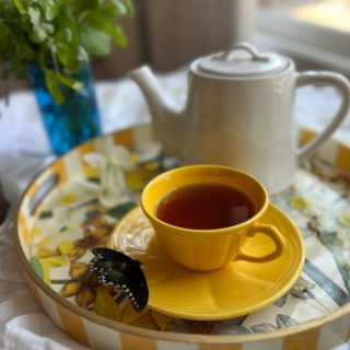 spring tea time with yellow cups and a white teapot.