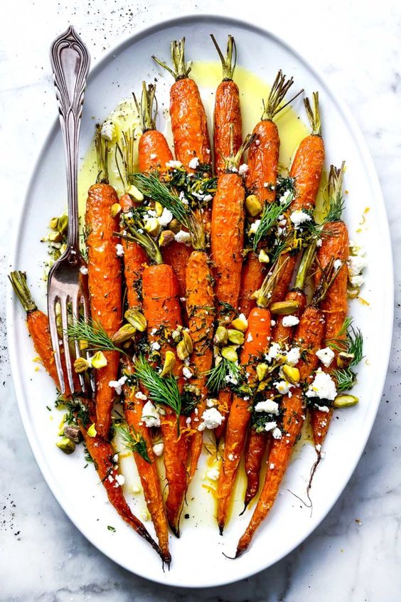  roasted carrots topped with a fresh and zesty dill gremolata, crumbled feta cheese, and pistachios.