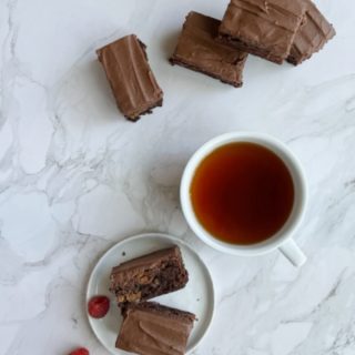 dulce de leche brownies and a cup of tea in a white cup.