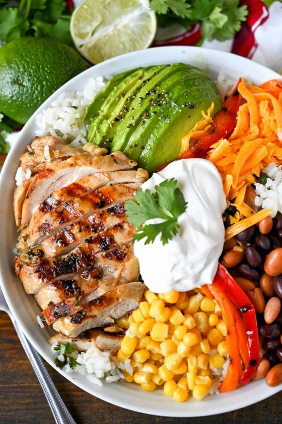 Grilled chicken salad with avocado, corn, sour cream and black beans. 