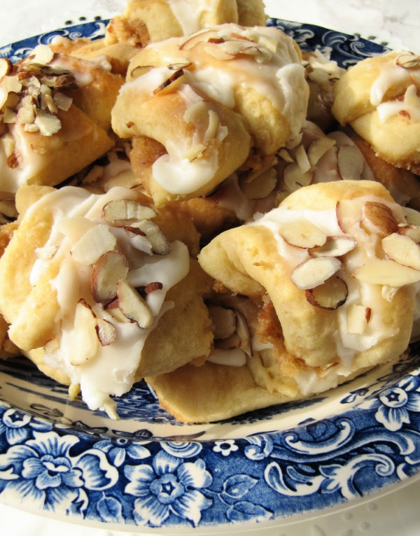 almond butterhorns piled on a plate. 